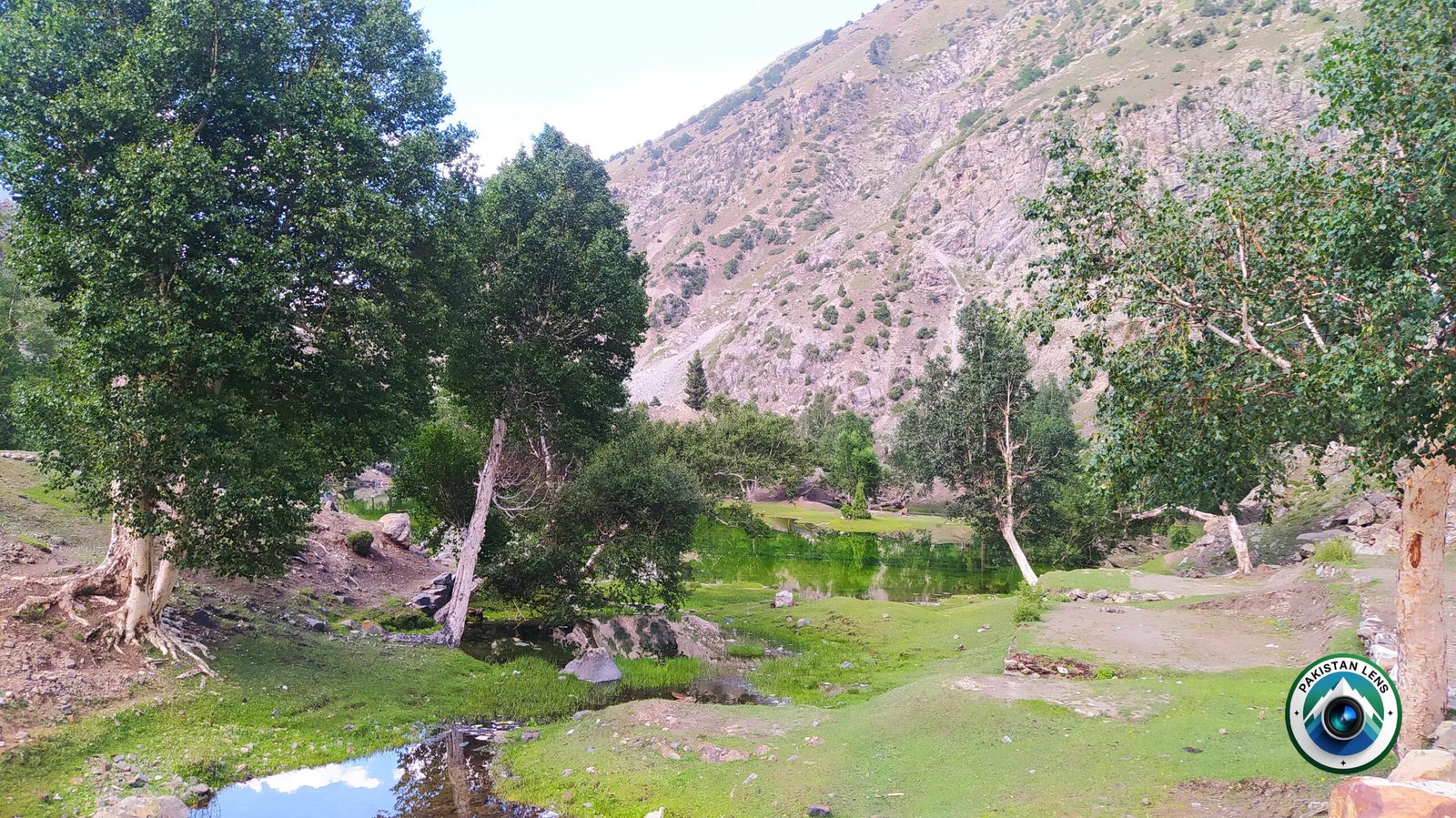 Calm water surface of Satrangi Lake with scenic surroundings