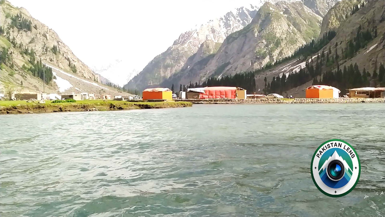 Clear lake water surrounded by mountains at Mahodand Lake in Swat