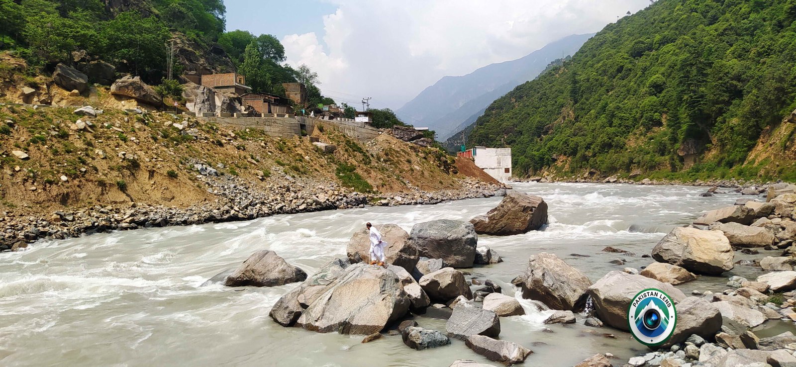 Road from Madyan to Bahrain with scenic mountain and river views.