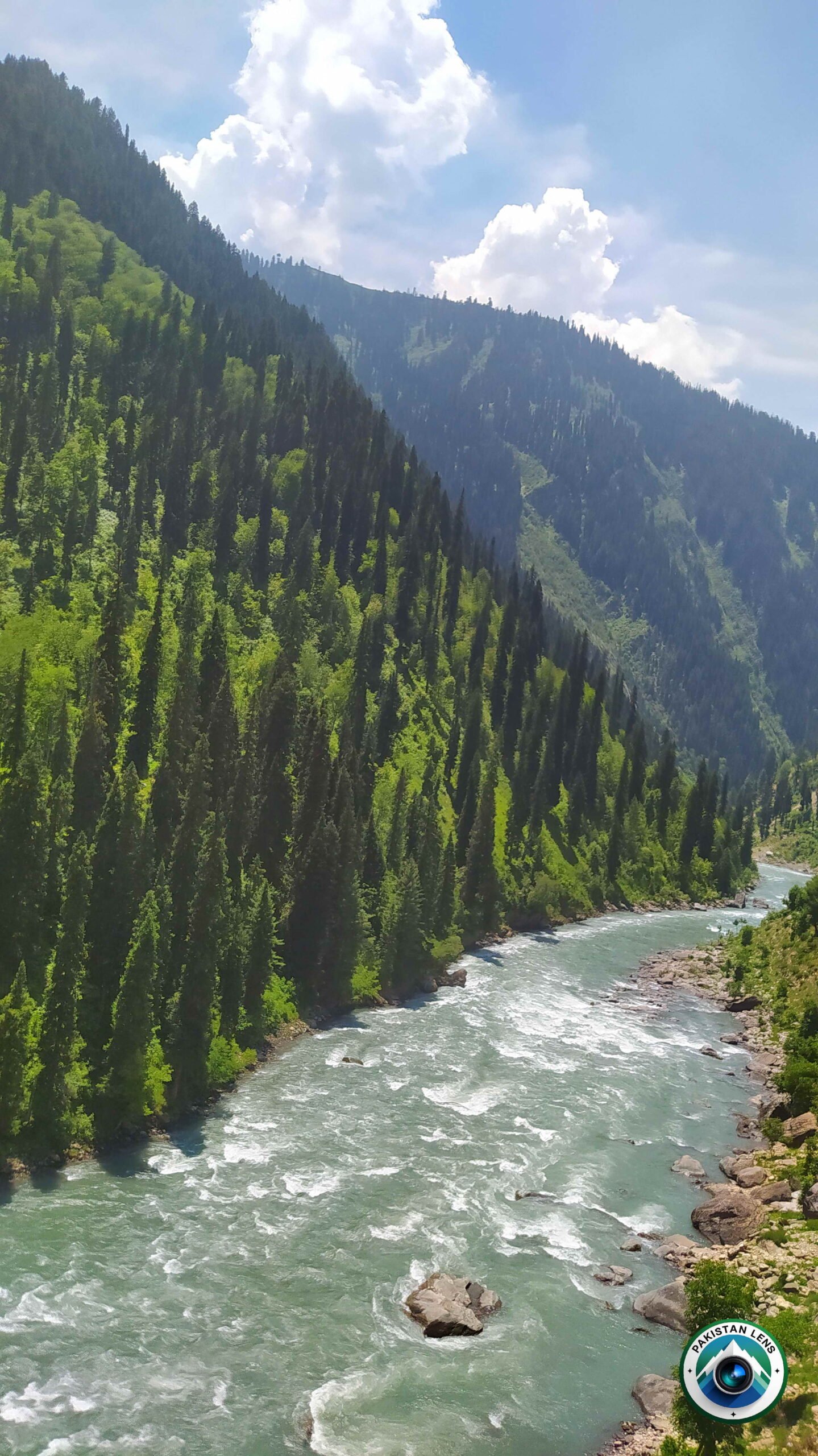 Fast-flowing river rapids surrounded by mountains on the way to Taobat
